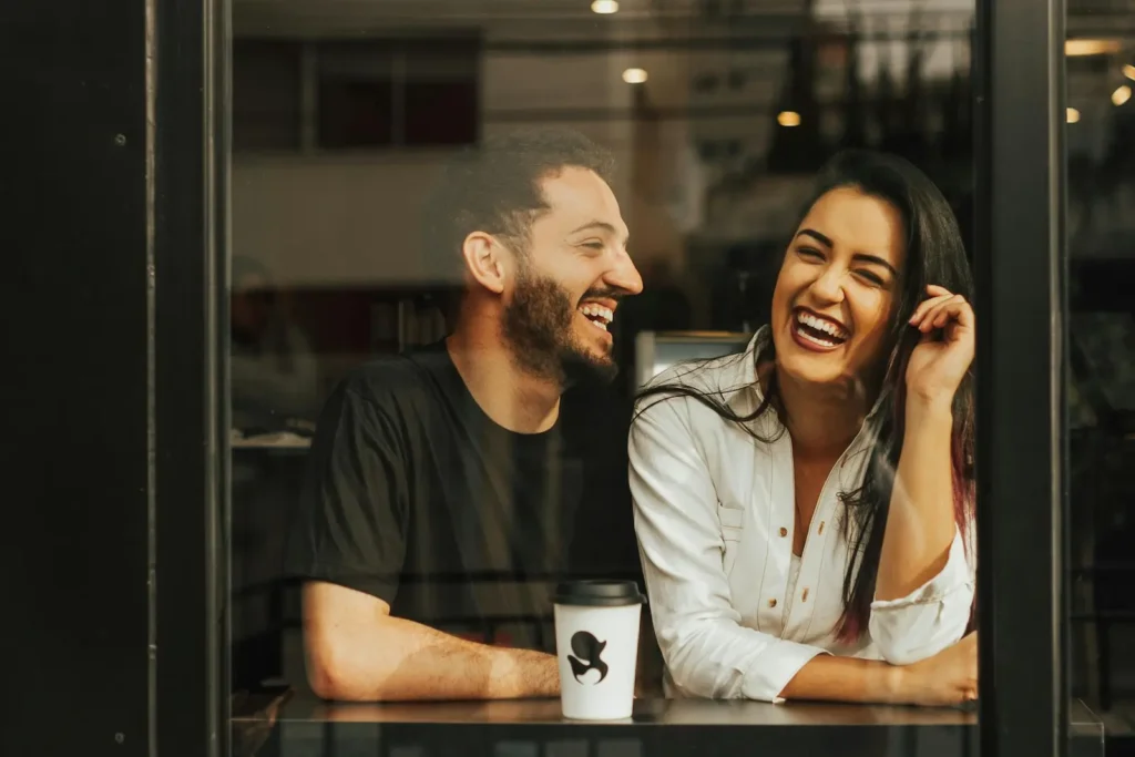 A girl and a boy enjoying their comfort place inside cafe