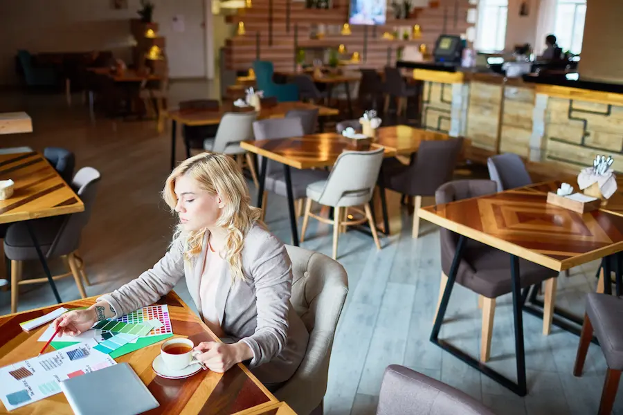 A woman working at an aesthetic cafe ambience