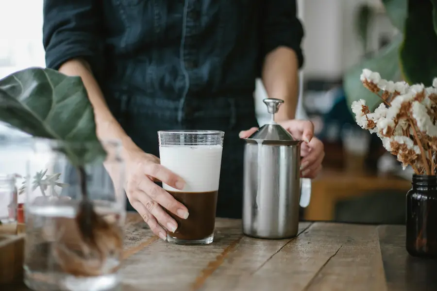 A barista preparing iced chocolate coffee