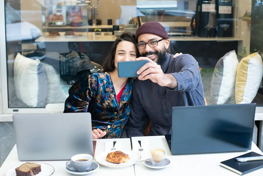 A man and a woman enjoying their personal moments at cafe elevenza