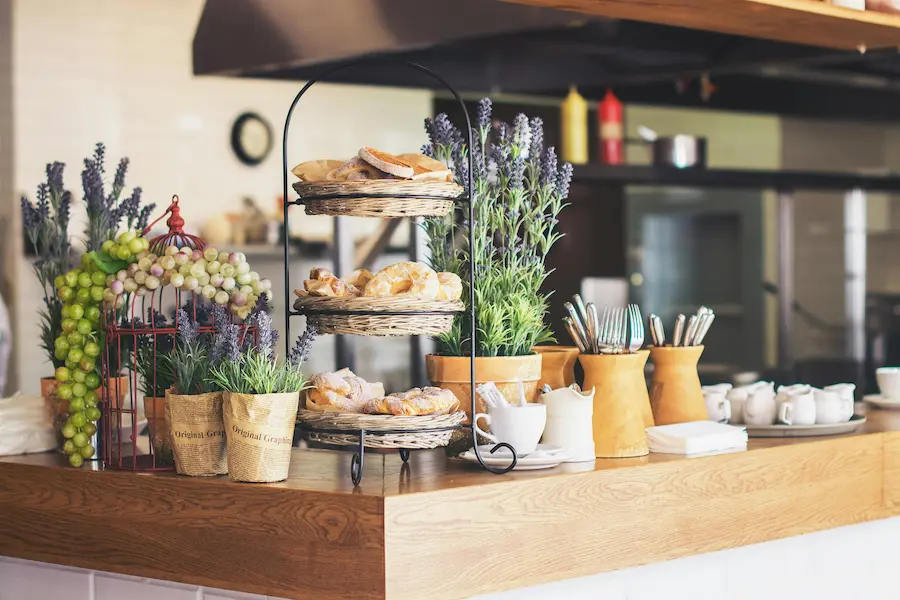 Breads arranged on a wooden table on a coffee shop